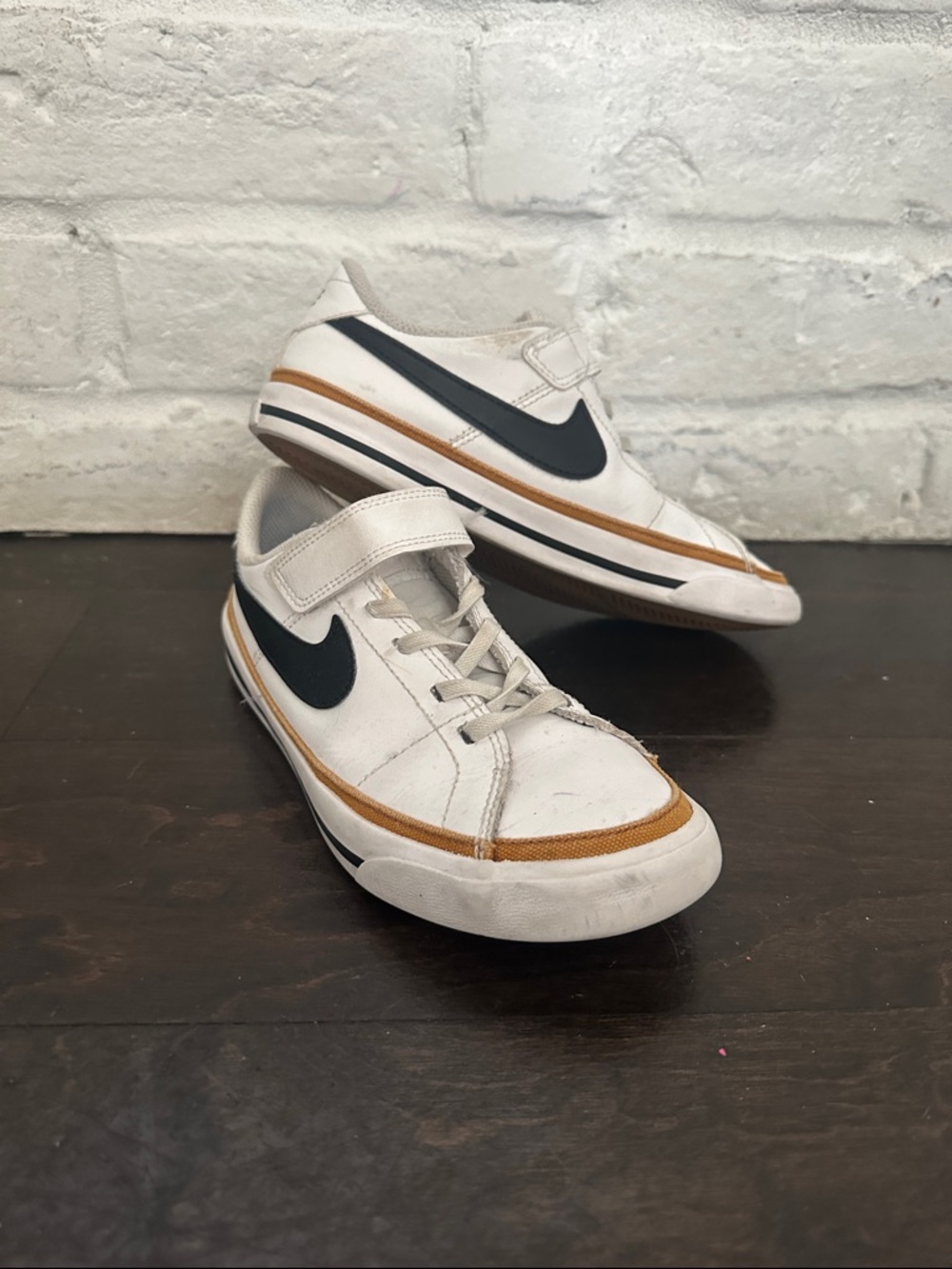 Nike White Low-Top Sneakers with Black Swoosh and Brown Trim